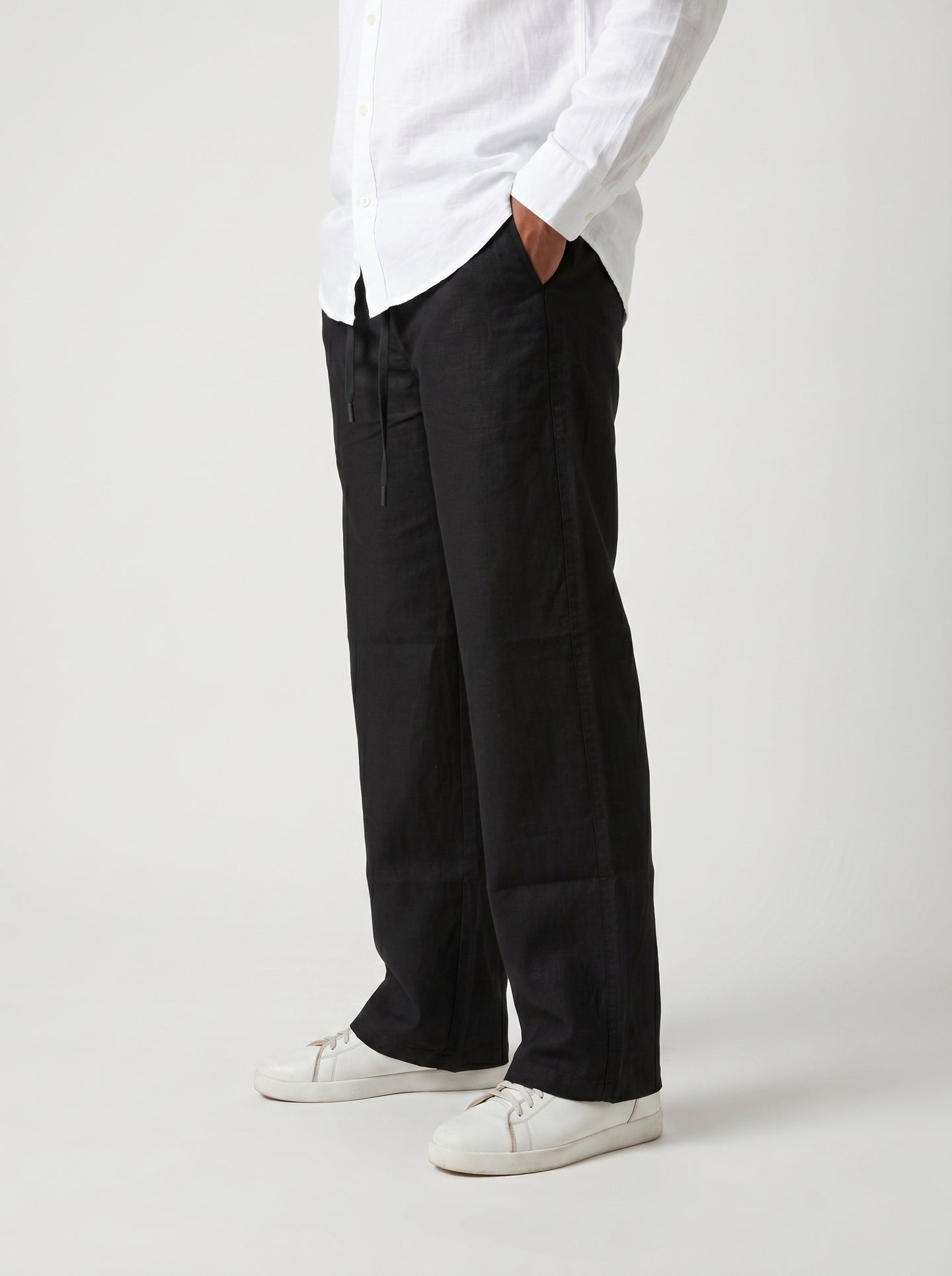 Black casual drawstring pants with roomy straight legs and gathered waistband
