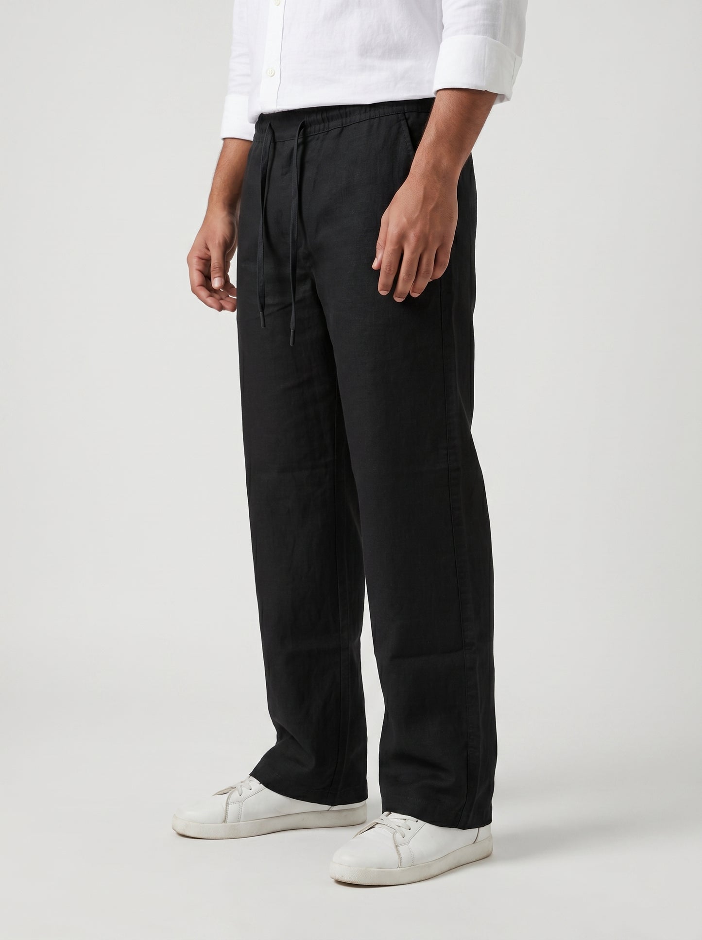 Black drawstring waist trousers with relaxed drape and straight wide-leg cut