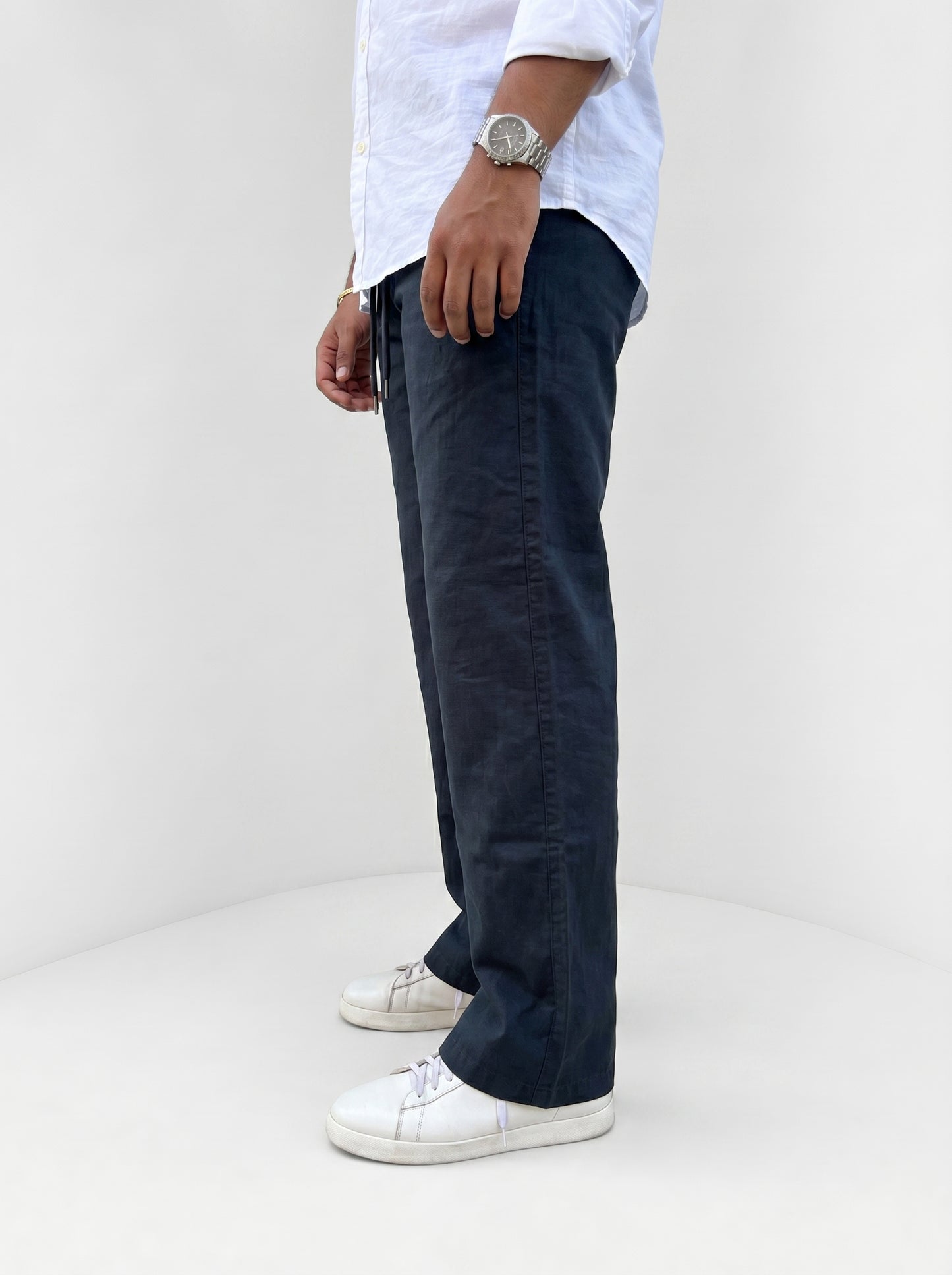Navy drawstring pants, relaxed fit, front view with pockets and tied waist