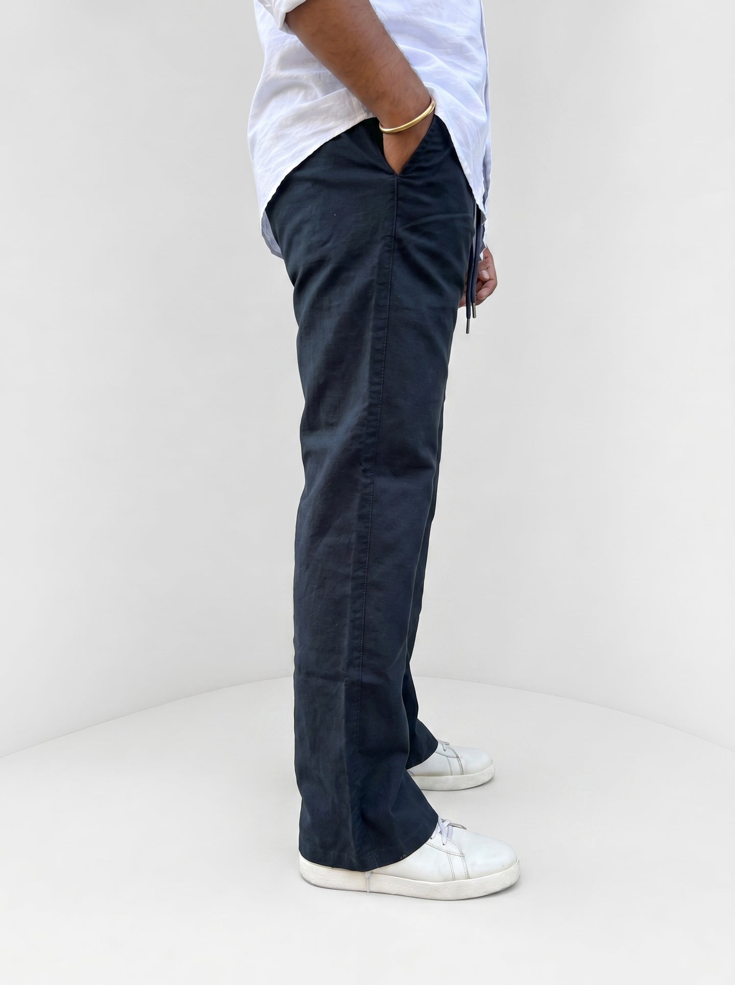 Navy drawstring pants, relaxed fit, side leg view with cuff and tie detail
