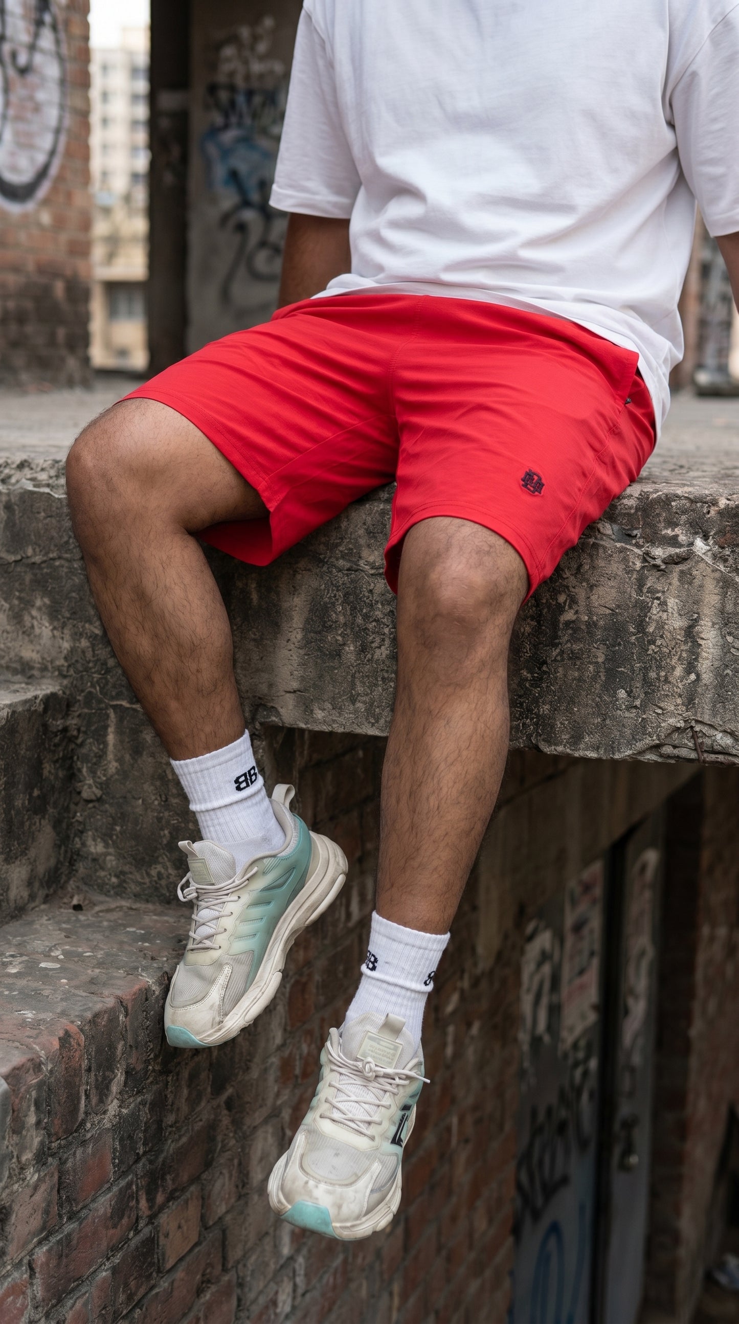 Red lightweight tech shorts, mid-thigh fit with small logo on leg