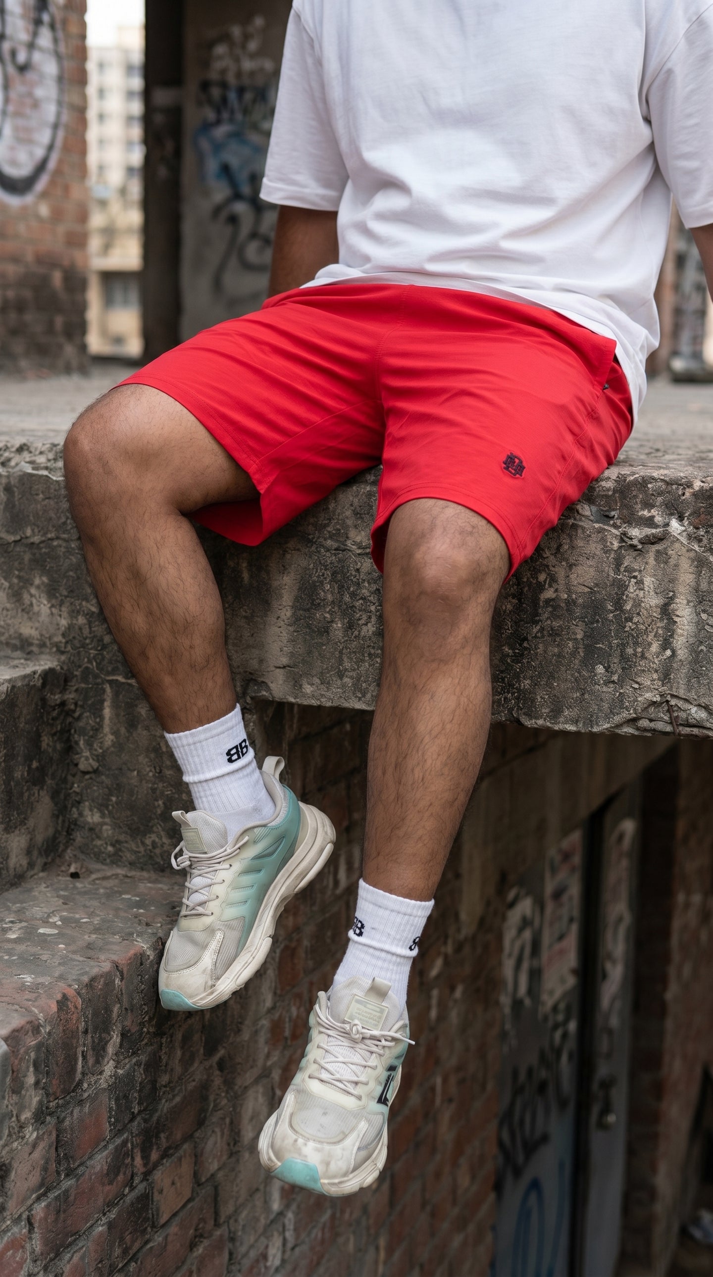 Red lightweight tech shorts, mid-thigh fit with small logo on leg