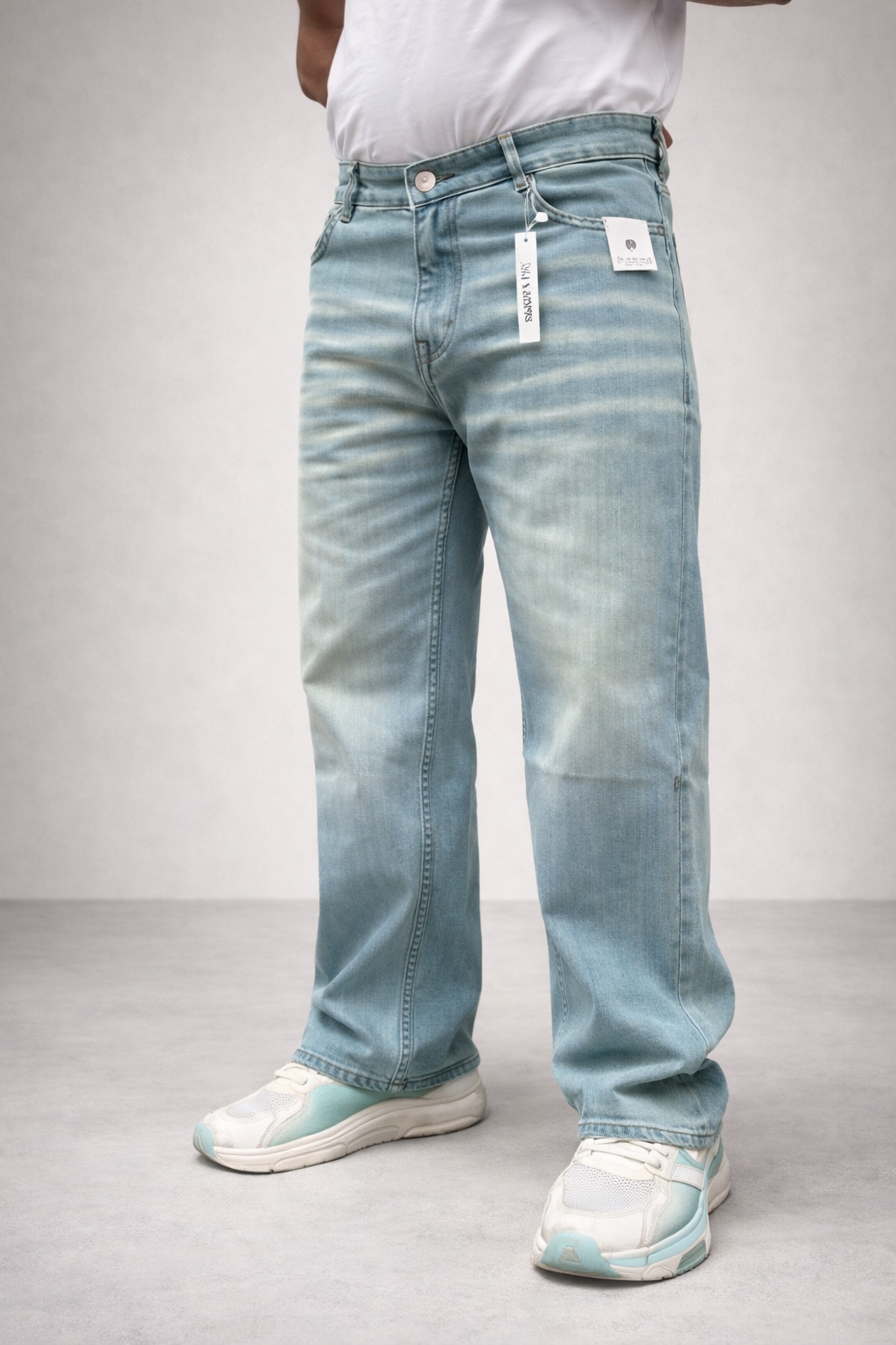 Light wash straight-fit jeans, back view with belt loops and hanging tags