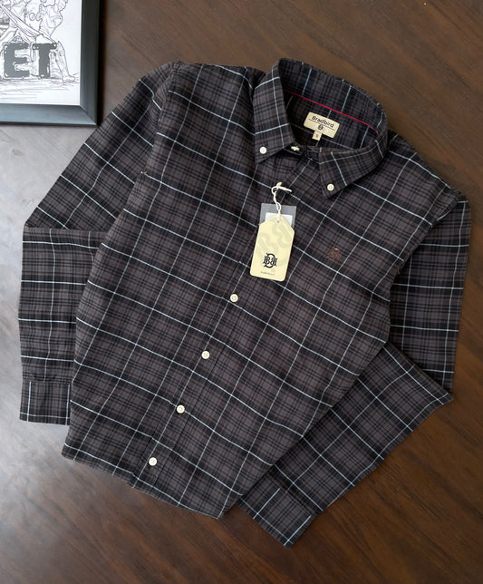 Oxford check button-up shirt laid flat, dark plaid with white lines and front buttons