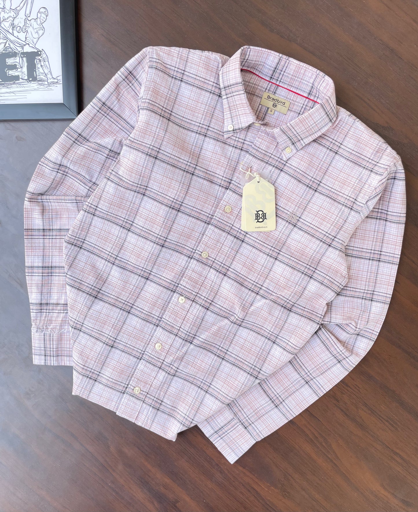 Pink and dark windowpane check oxford shirt laid flat, button-up collar and cuffs