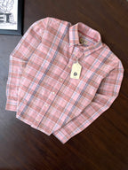 Folded pink plaid oxford button-up shirt with tag on collar