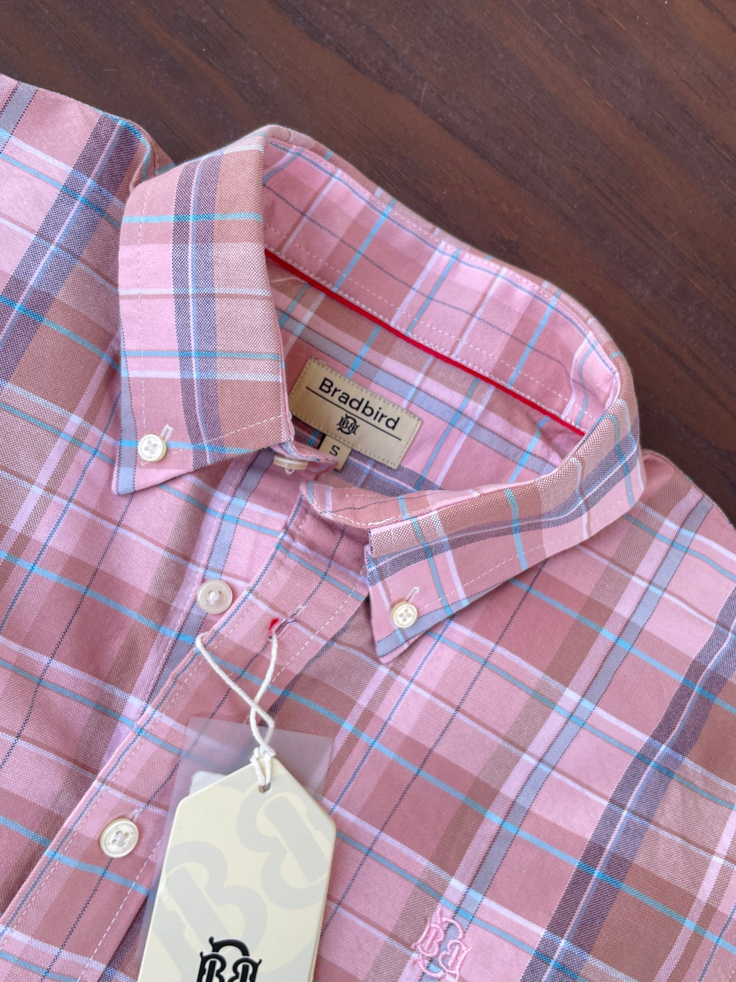 Pink plaid oxford shirt neckline and interior label with hanging tag