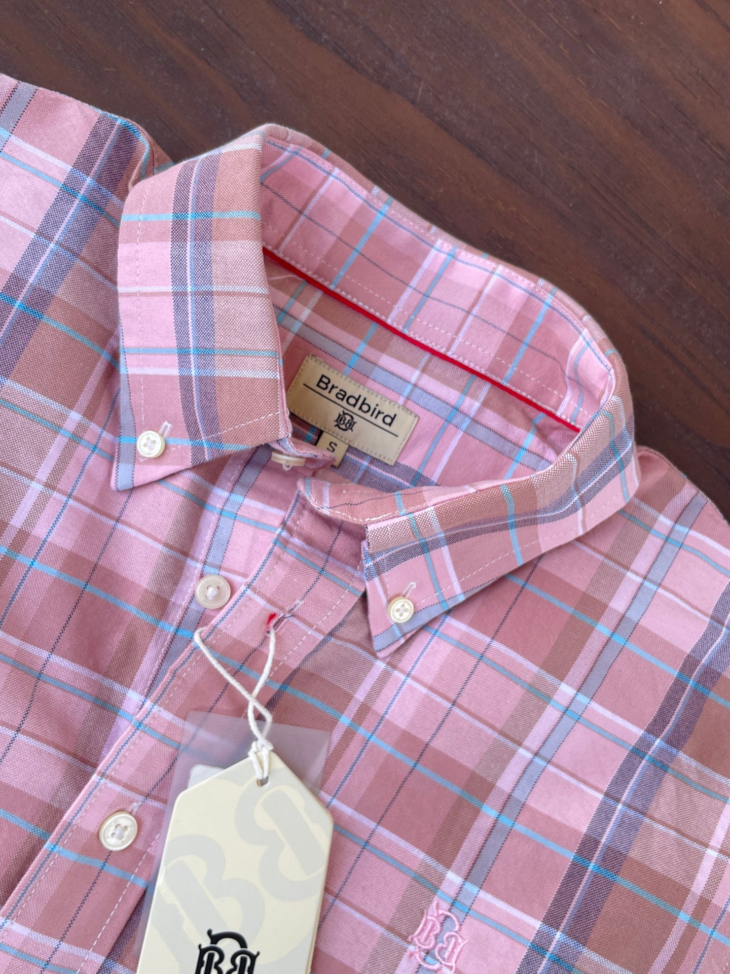 Pink plaid oxford shirt neckline and interior label with hanging tag