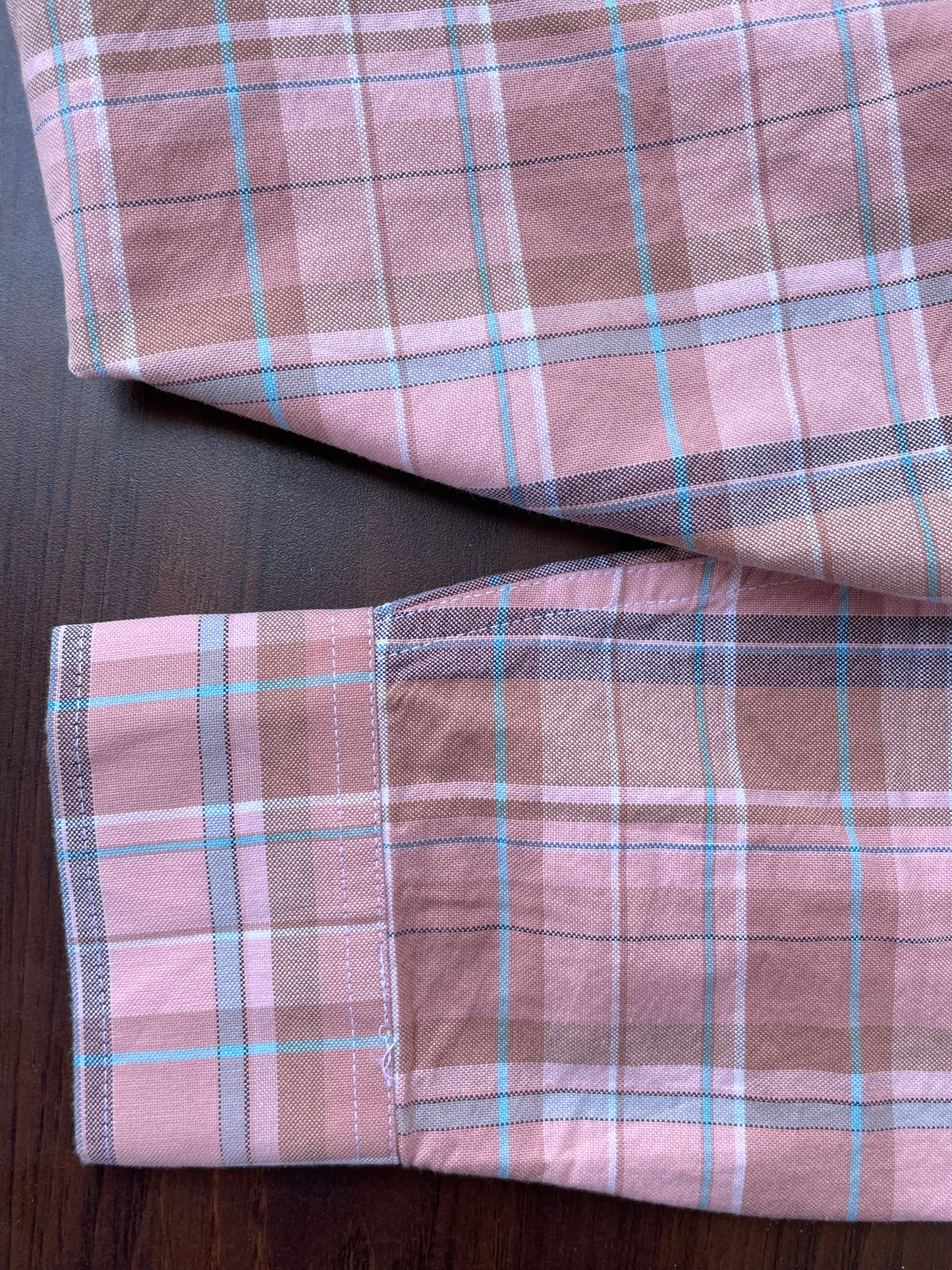 Pink plaid oxford shirt cuff and sleeve seam detail