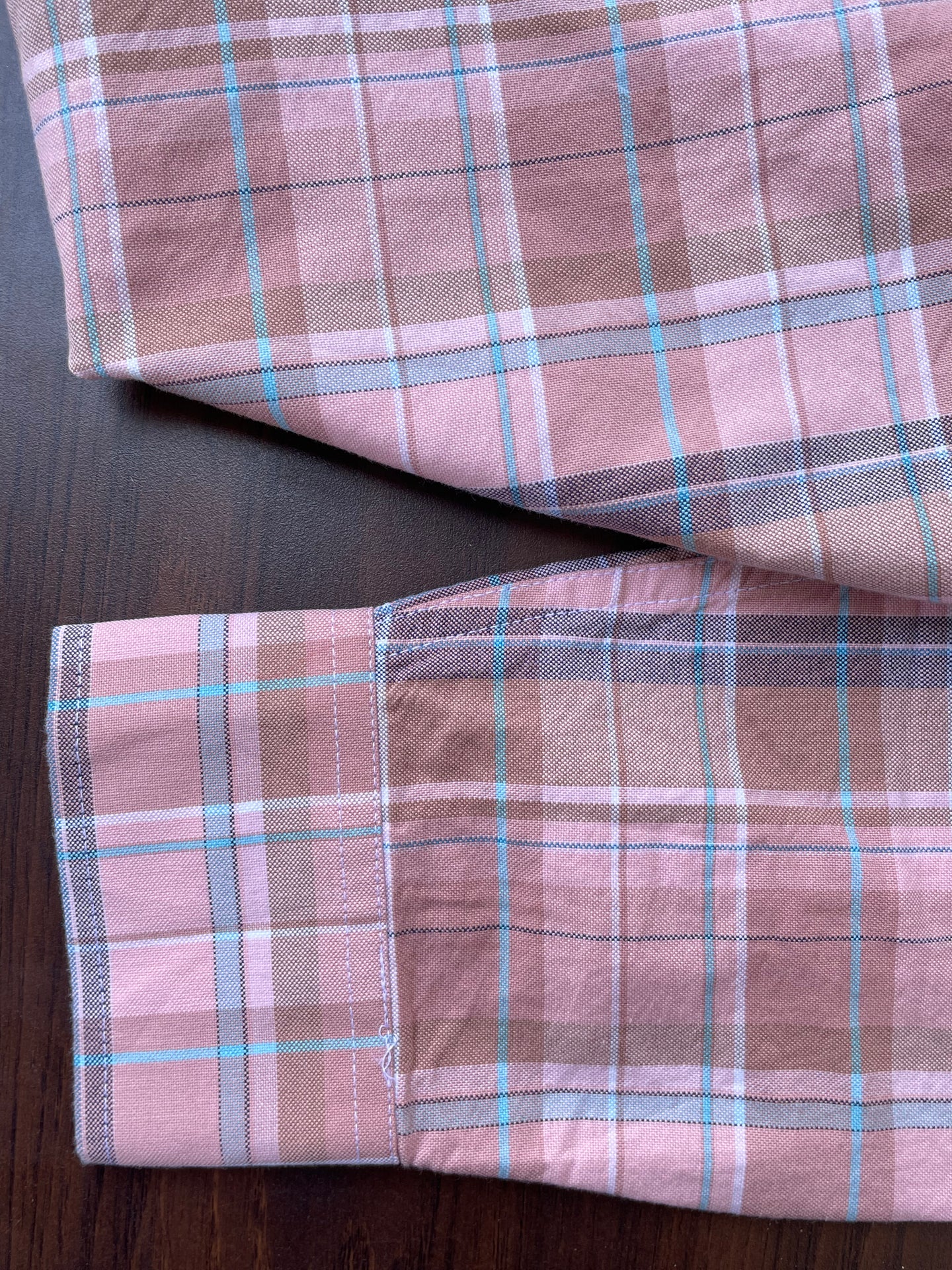 Pink plaid oxford shirt cuff and sleeve seam detail