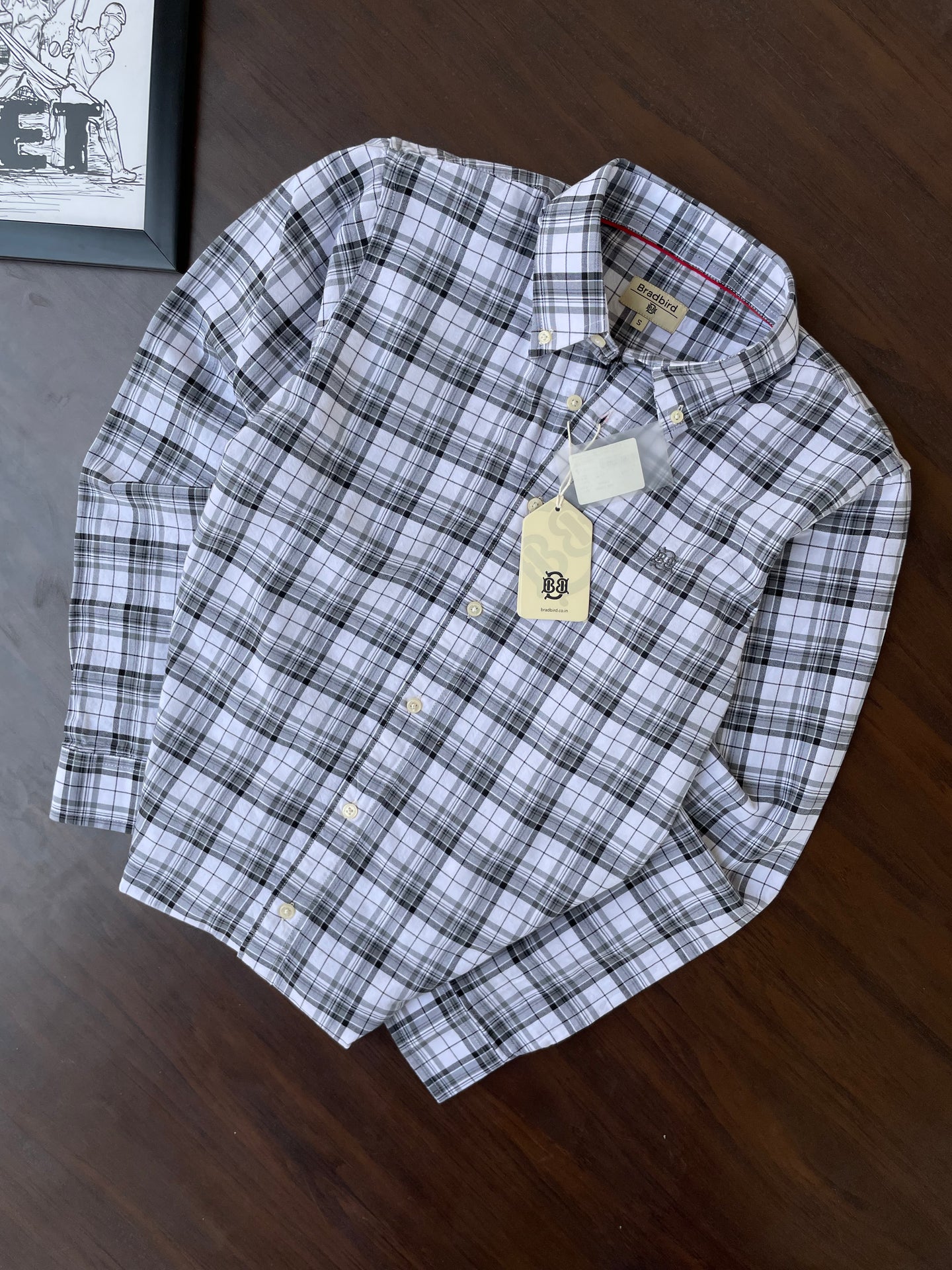 Folded black-and-white check button-up shirt with button-down collar
