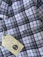 Close-up black-and-white check oxford shirt with chest logo patch and hang tag