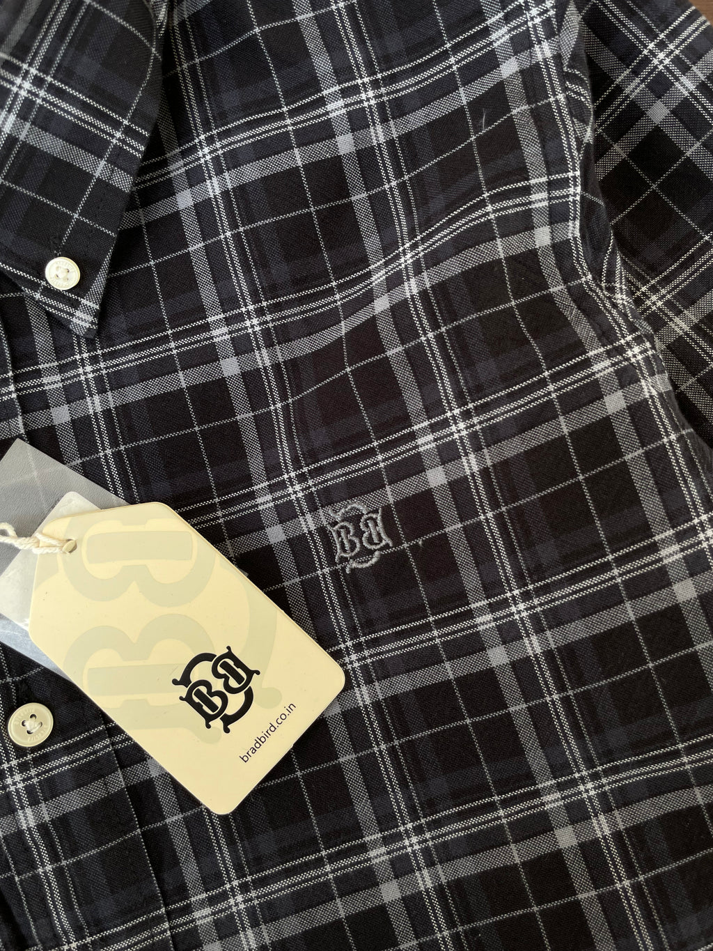 Black check Oxford shirt close-up: white buttons and embroidered chest logo