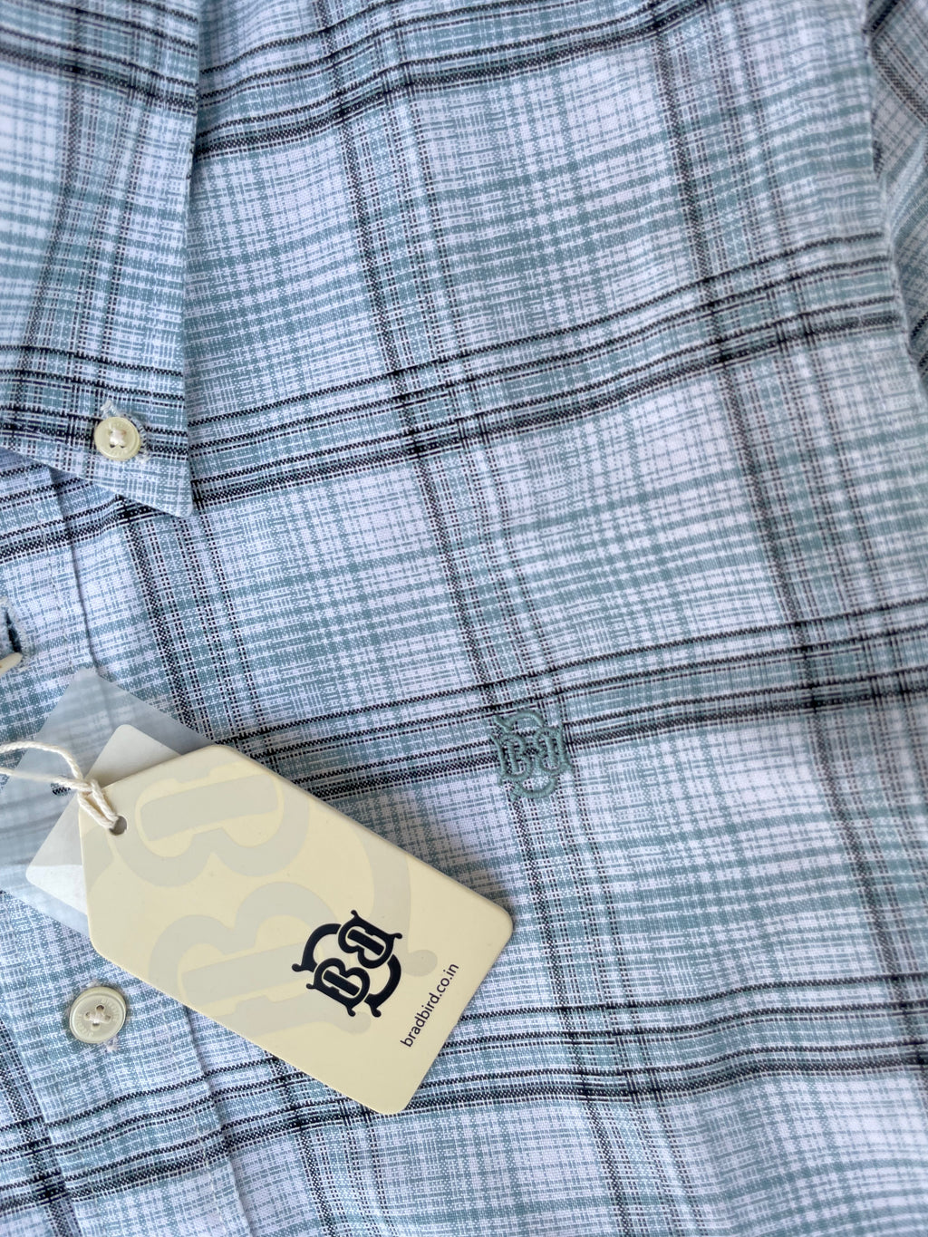 Mint-blue oxford check button-up shirt front with logo embroidery and tag