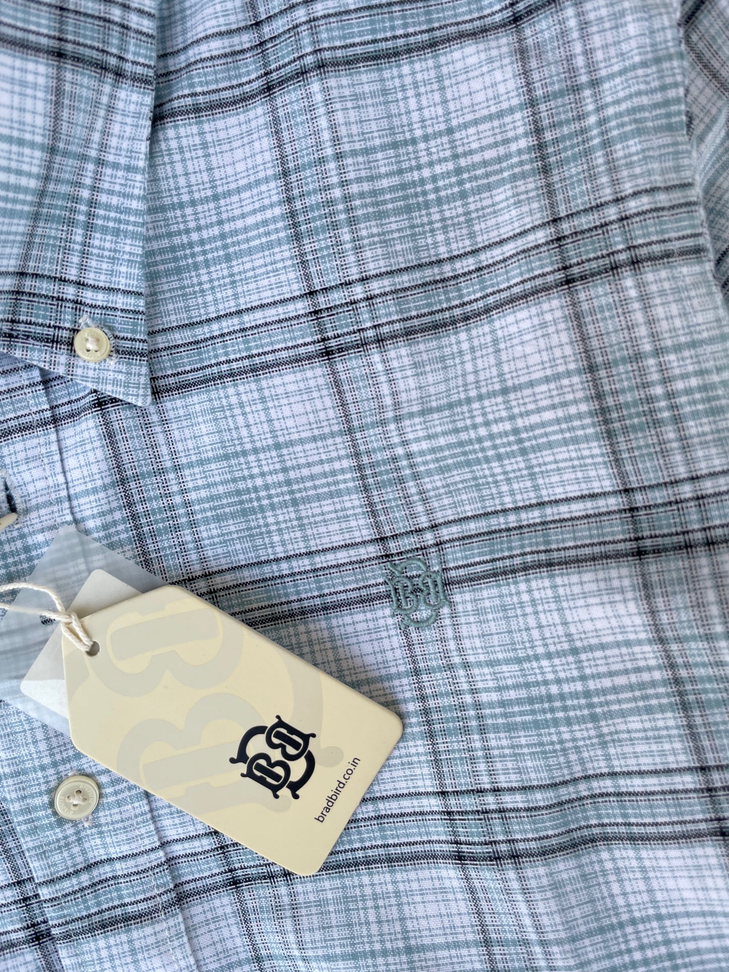 Mint-blue oxford check button-up shirt front with logo embroidery and tag