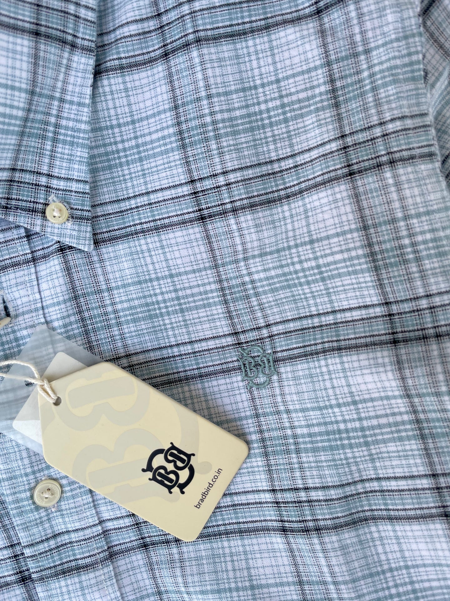 Mint-blue oxford check button-up shirt front with logo embroidery and tag