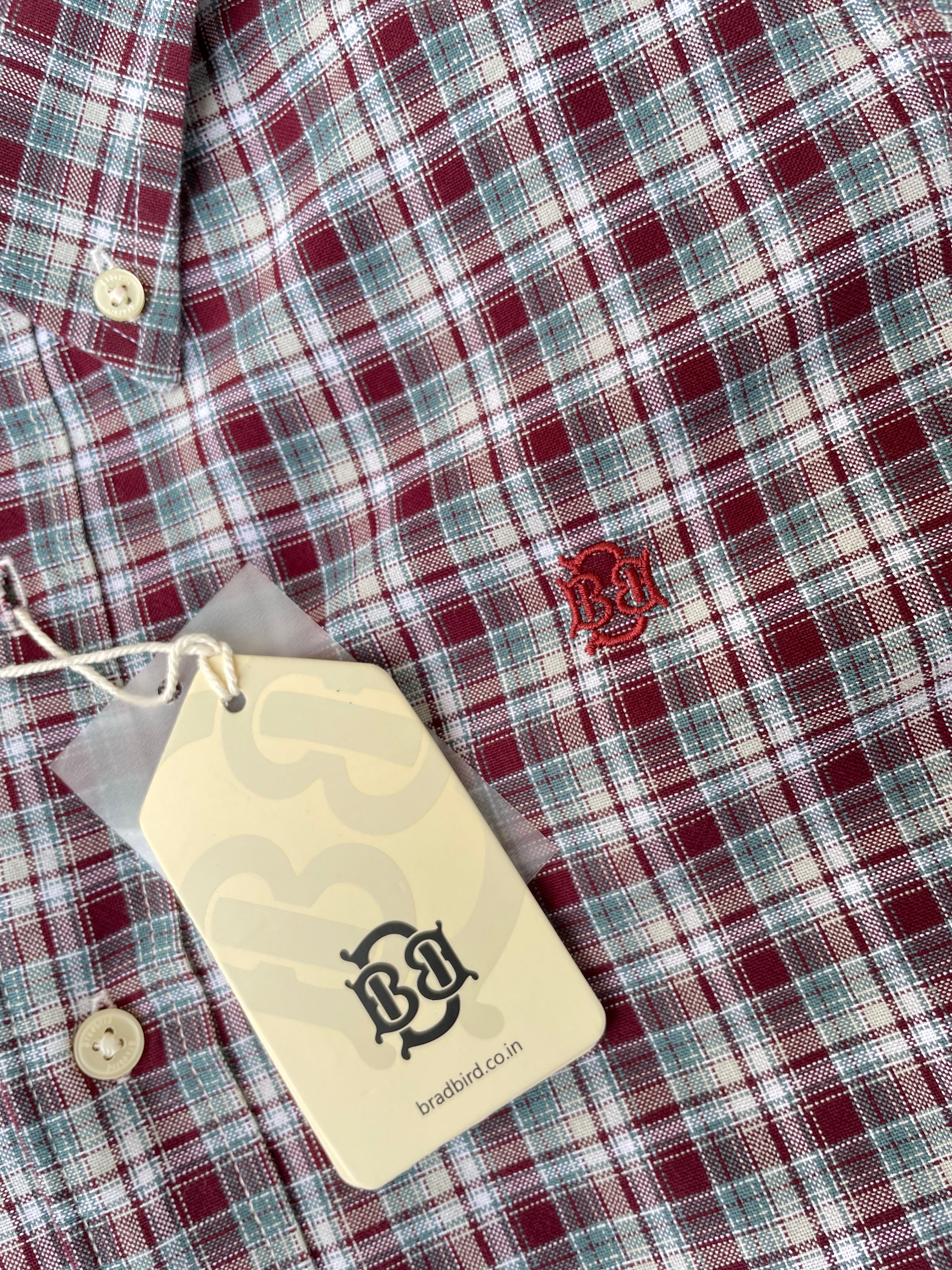 Red, green, and white plaid oxford shirt chest detail with embroidered logo
