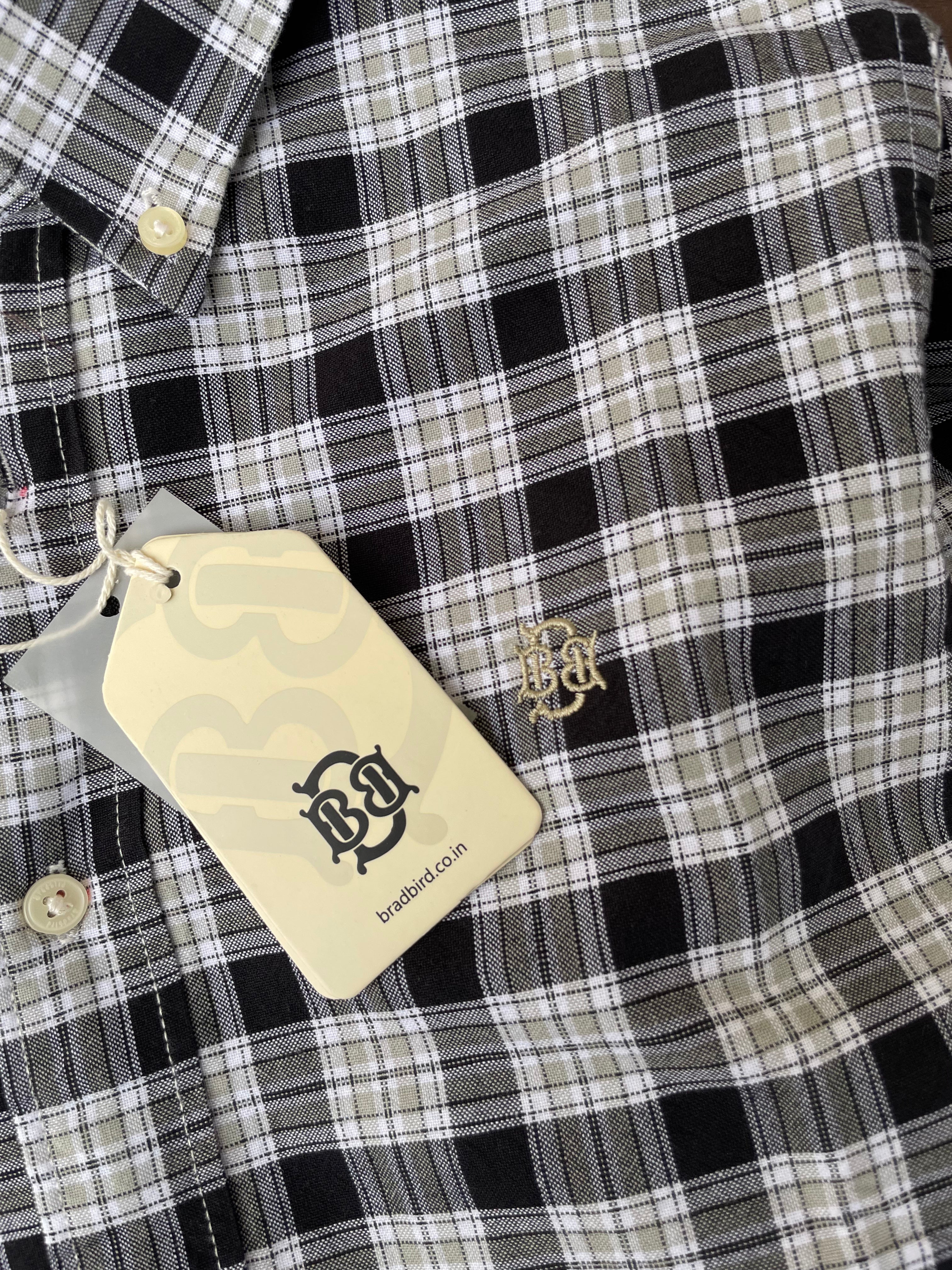 Close-up: black-and-beige plaid Oxford shirt, gold-tone buttons, button-down collar