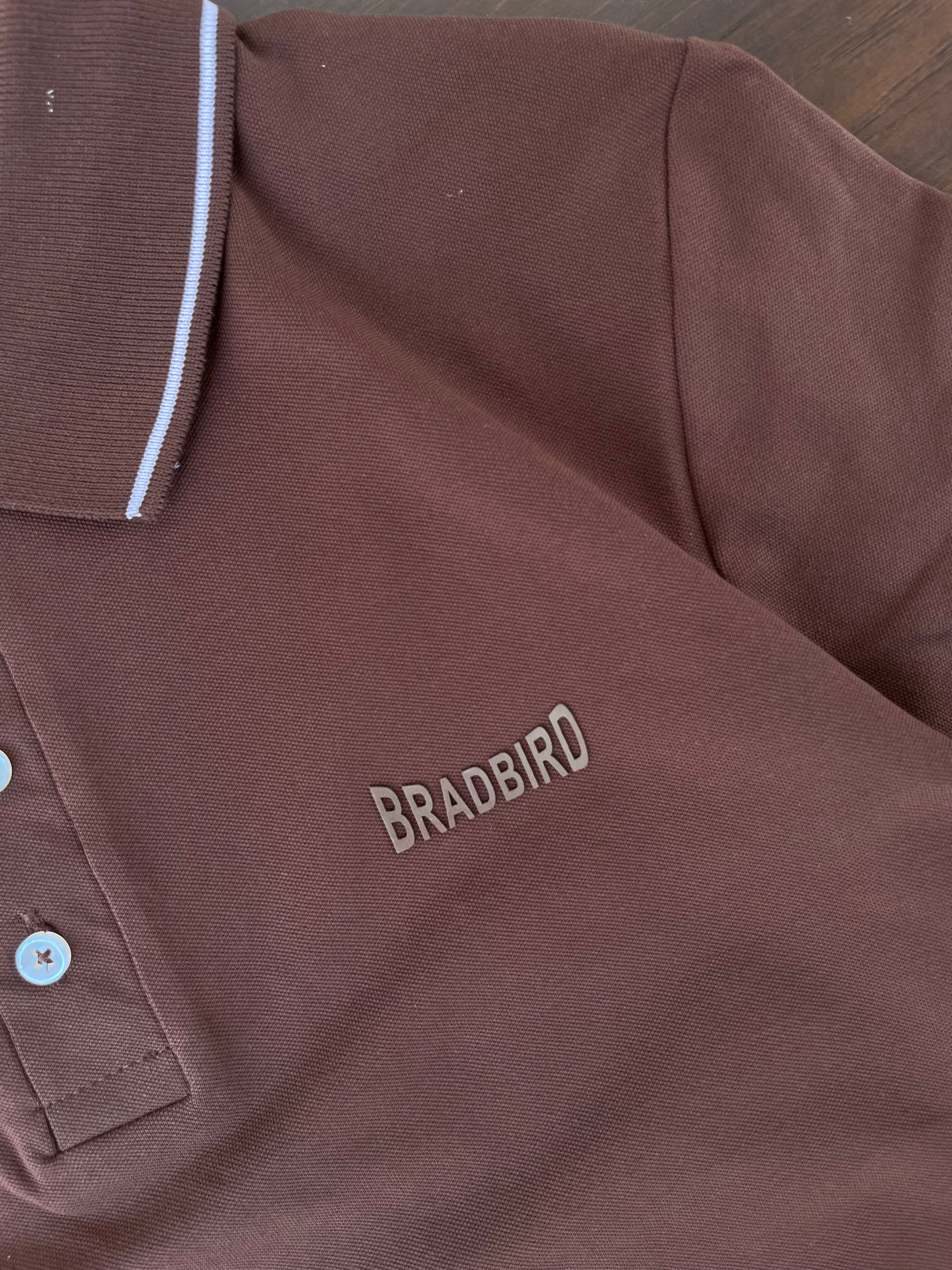 Coffee brown polo shirt chest logo with button placket and white contrast collar trim.