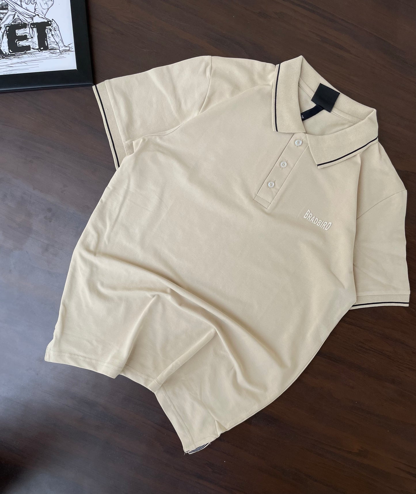 Cream polo shirt, short-sleeve with button placket and navy-trim collar