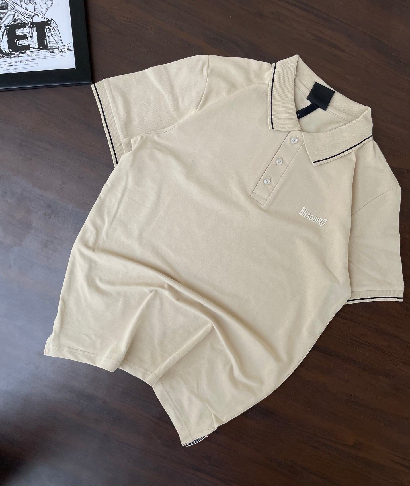 Cream polo shirt, short-sleeve with button placket and navy-trim collar