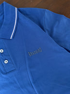 Blue polo shirt close-up of button placket and Bradbird chest logo