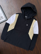 Black hooded windbreaker with sand and white panels on sleeves, zip front