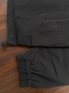Black windbreaker sleeve cuff with elastic hem and small drawstring stopper