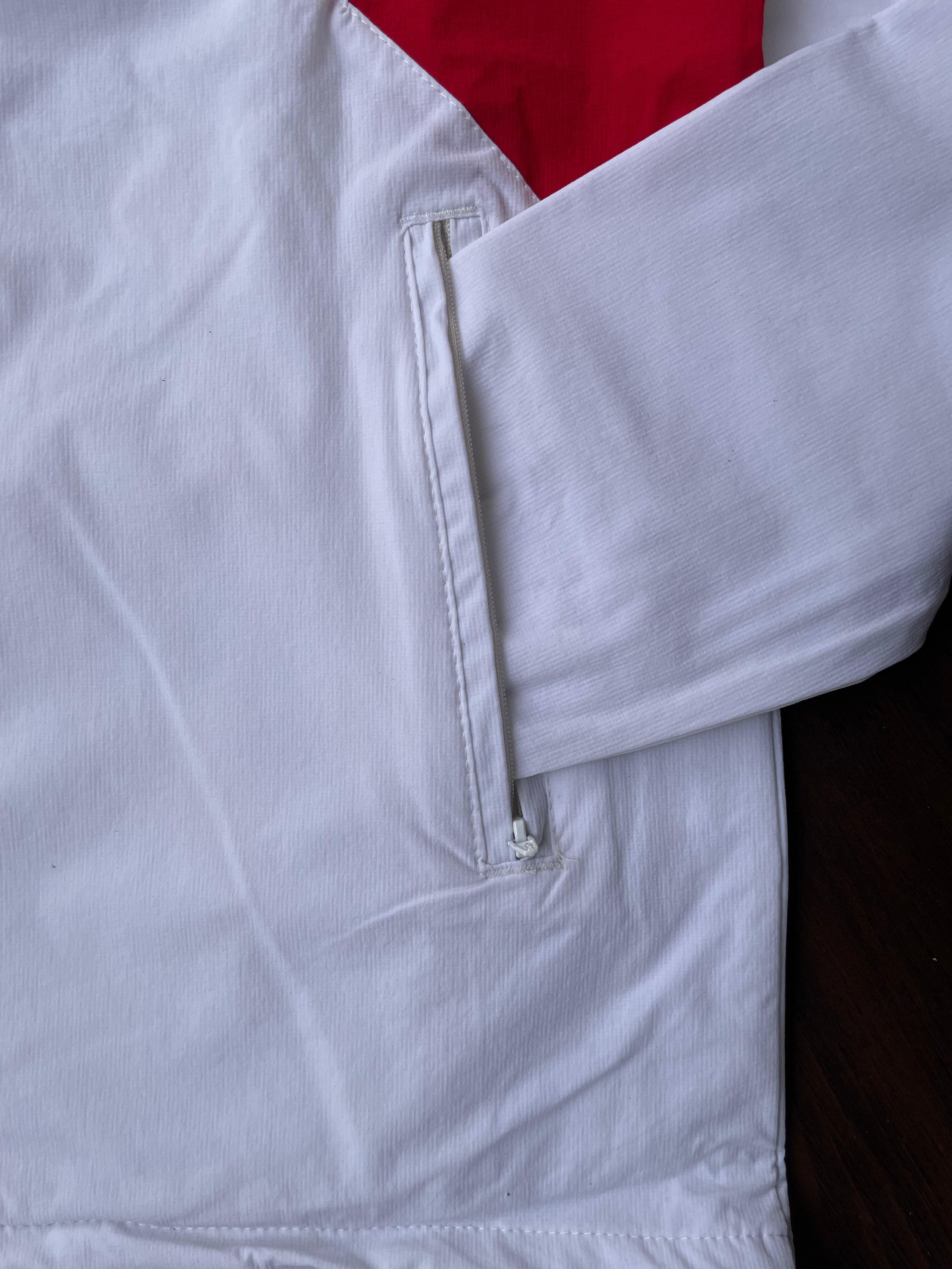 White windbreaker sleeve cuff with elastic seam and zippered pocket detail