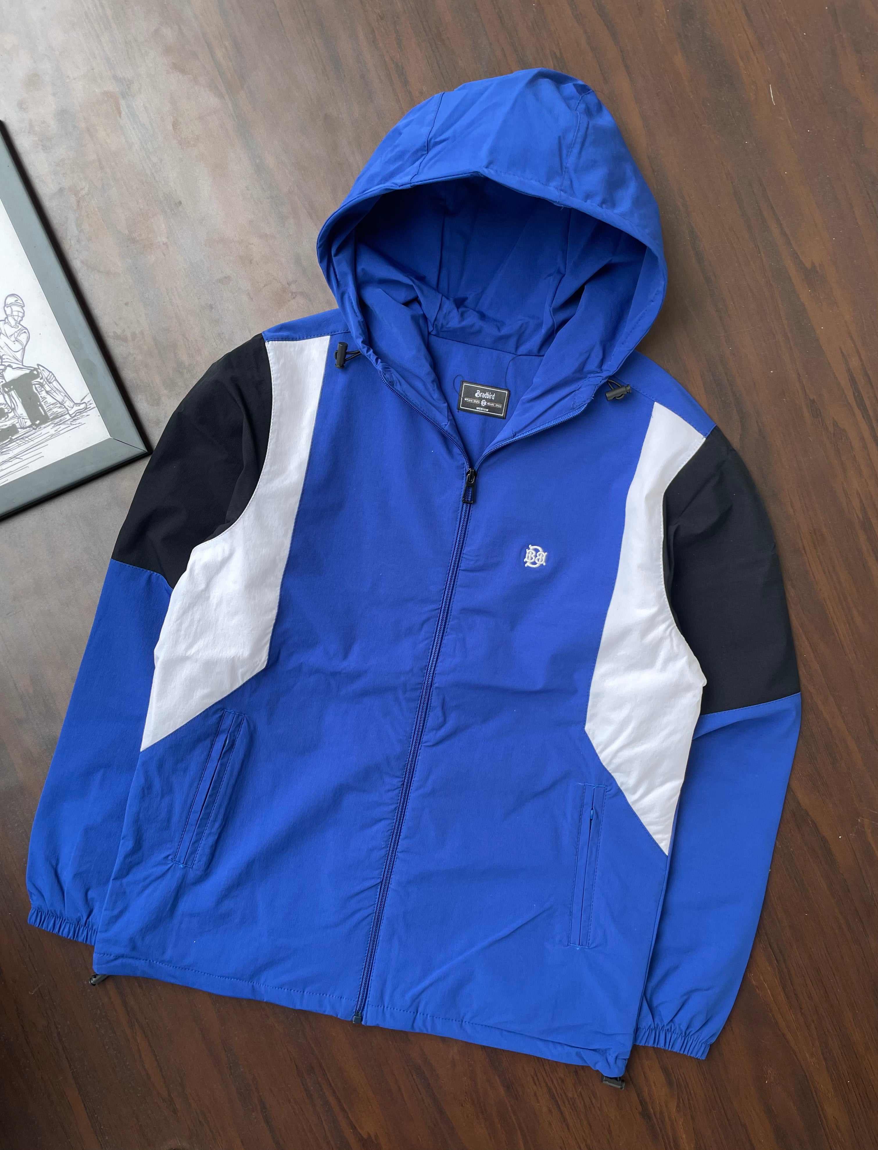 Cobalt hooded windbreaker with front zipper and white-black side panels