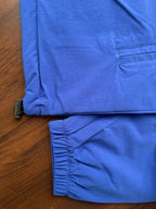 Blue windbreaker hem with adjustable drawstring and ribbed sleeve cuff
