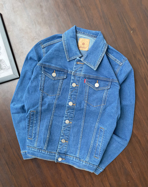 Blue medium-wash denim trucker jacket with pointed collar and chest pockets