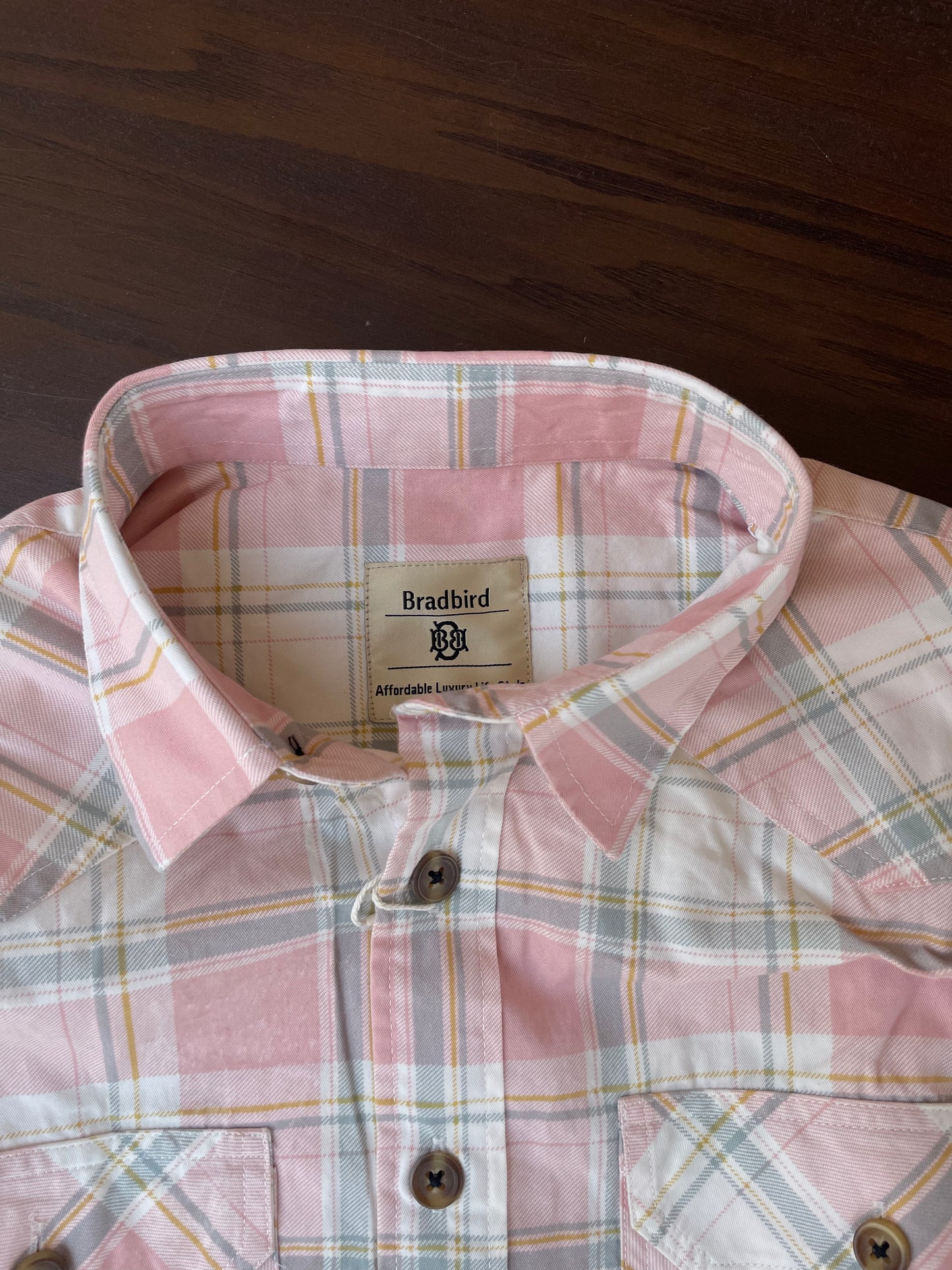 Dusty pink plaid western shirt collar and button placket close-up