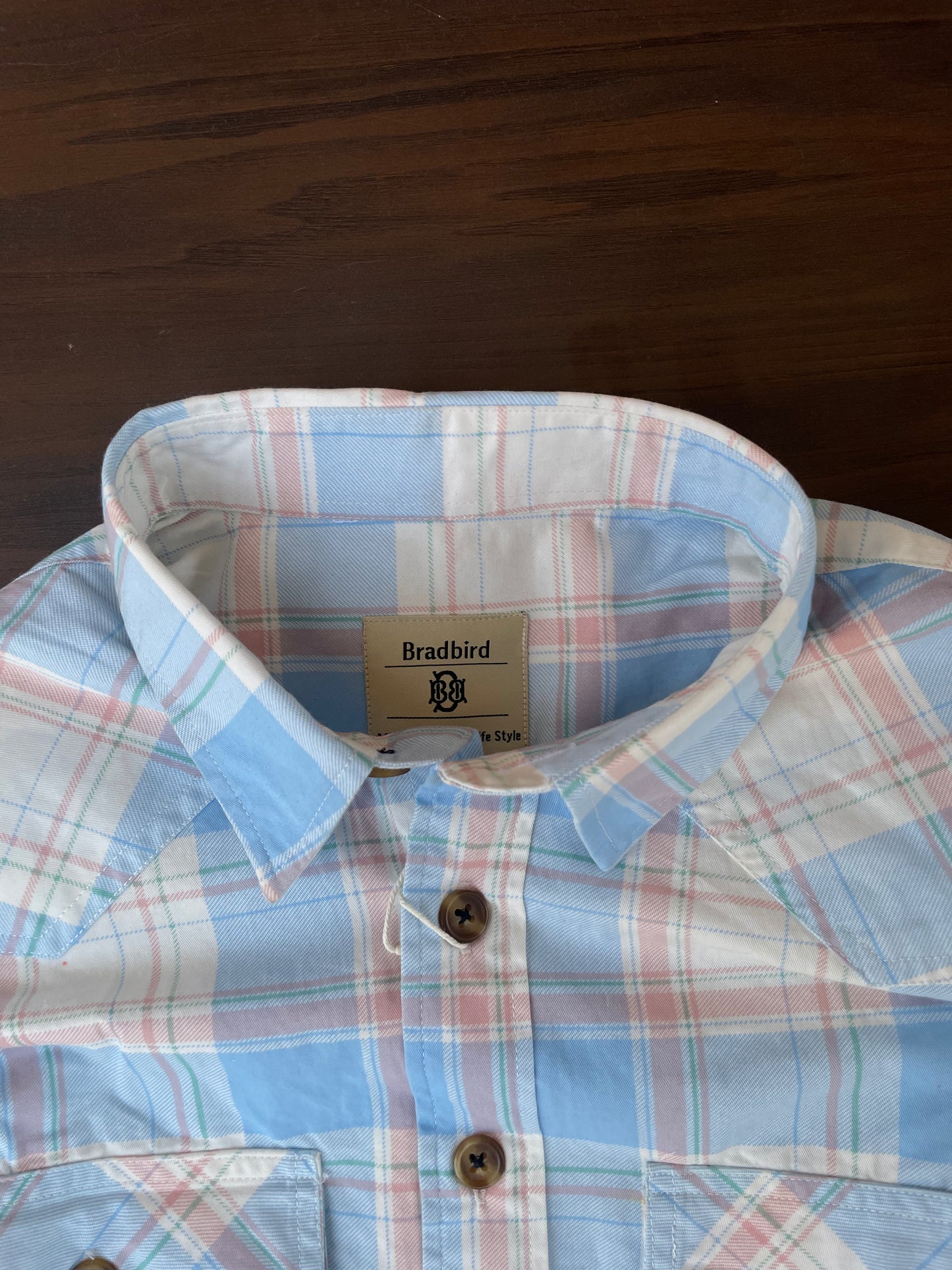 Sky blue plaid shirt collar and button placket, interior tag visible