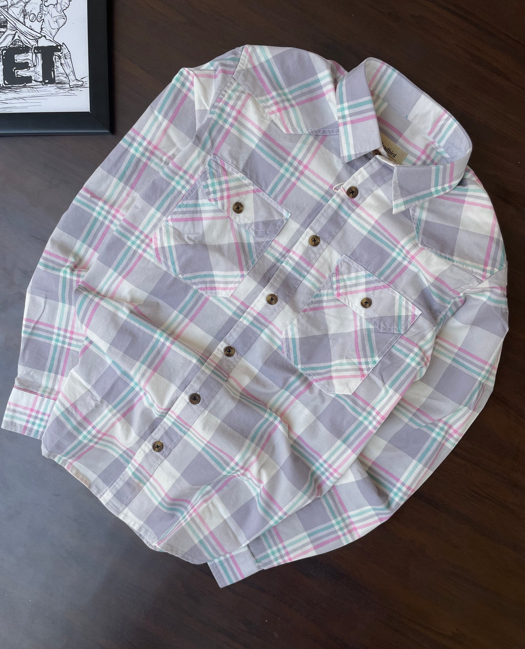 Lavender-grey plaid western shirt with pointed yokes and two chest pockets, flat lay