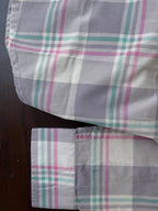 Sleeve cuff and side hem of lavender-grey plaid western shirt, buttoned cuff
