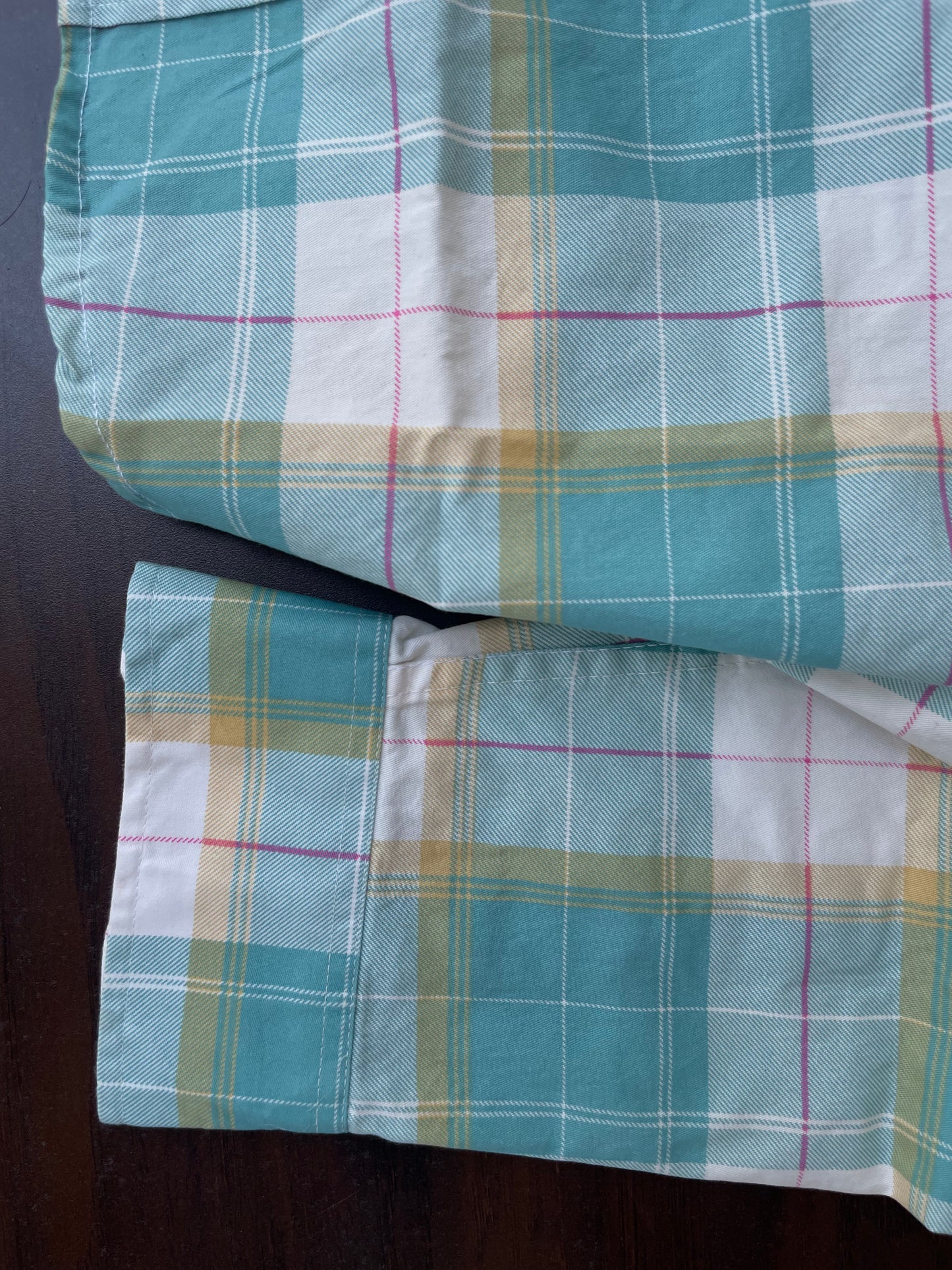 Sleeve cuff detail on aqua turquoise plaid western shirt with button closure