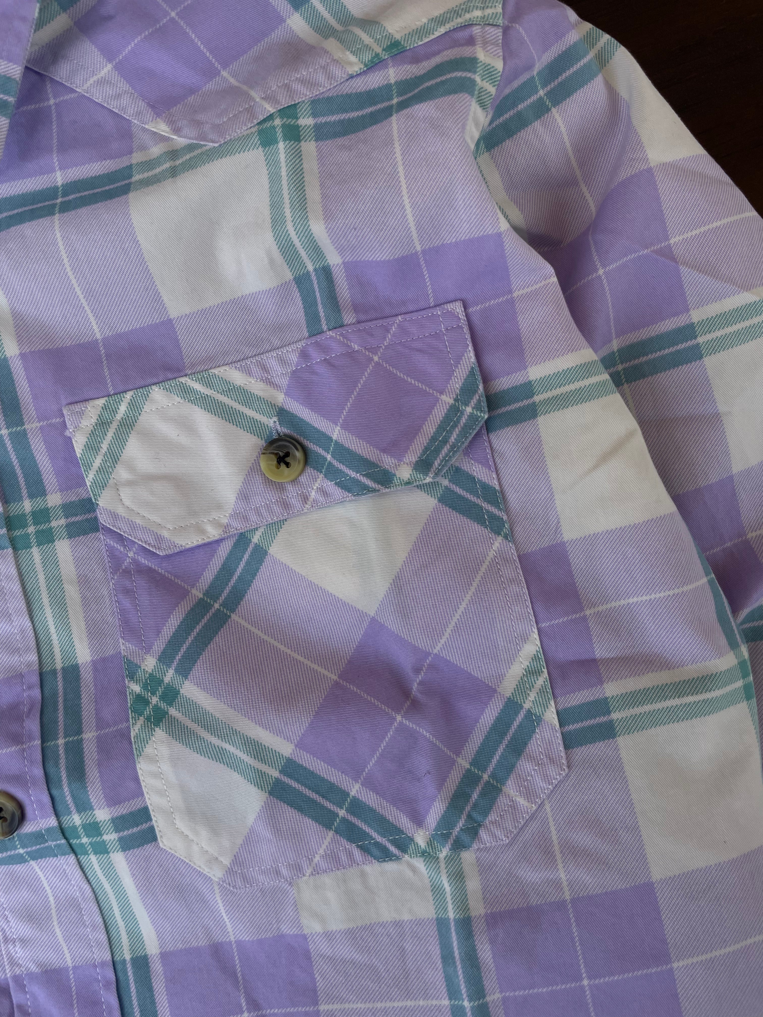 Purple and teal plaid western shirt chest pocket flap with button detail