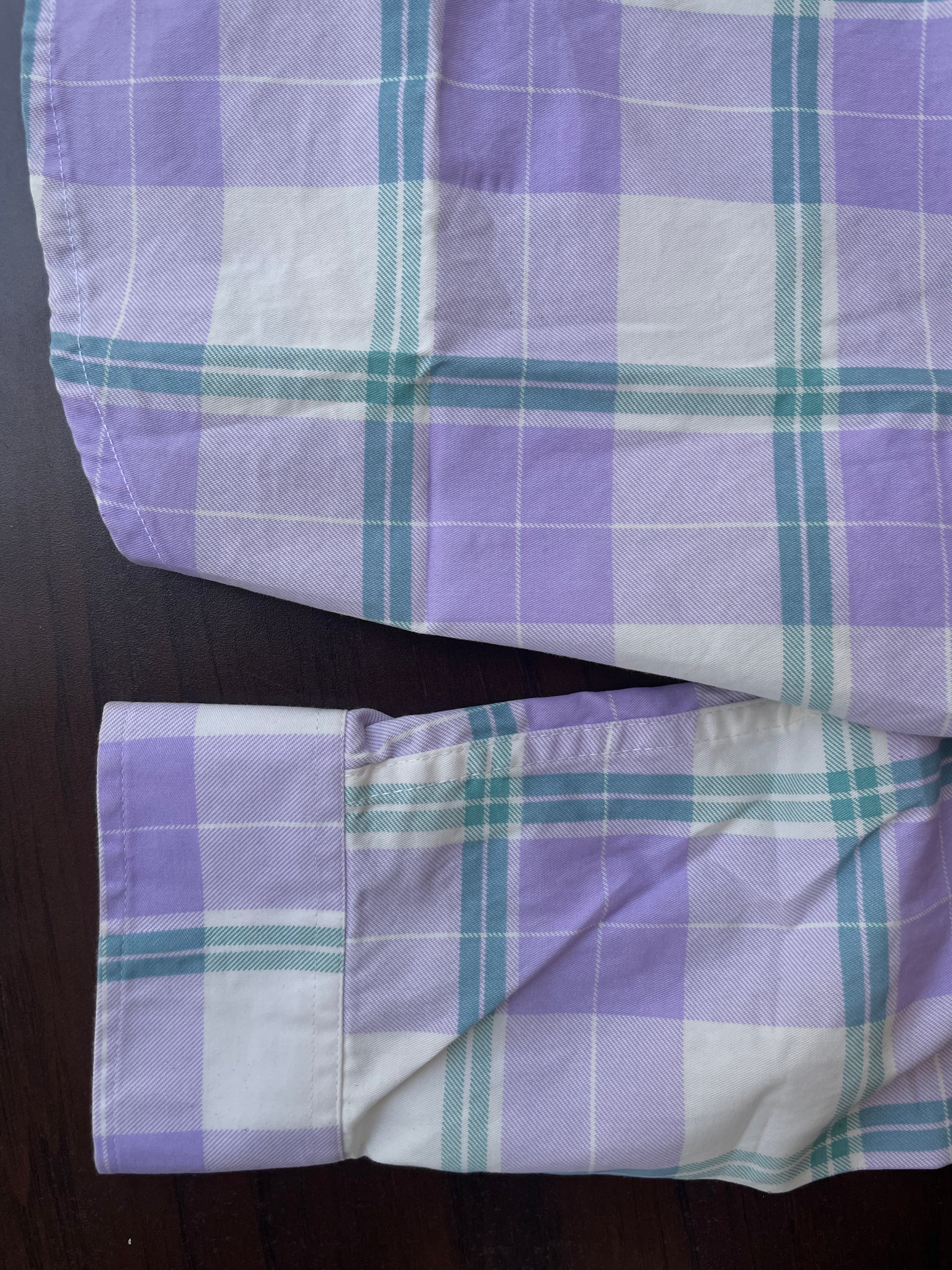 Purple and teal plaid sleeve cuff and hem with contrast stitched edge