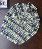 Folded green and navy large-check cotton shirt with button front and chest patch pockets