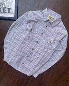 Folded men’s plaid button-up shirt, white base with grey and green grid checks