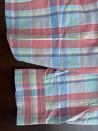 Red, blue, and green check casual shirt cuff detail with buttoned sleeve