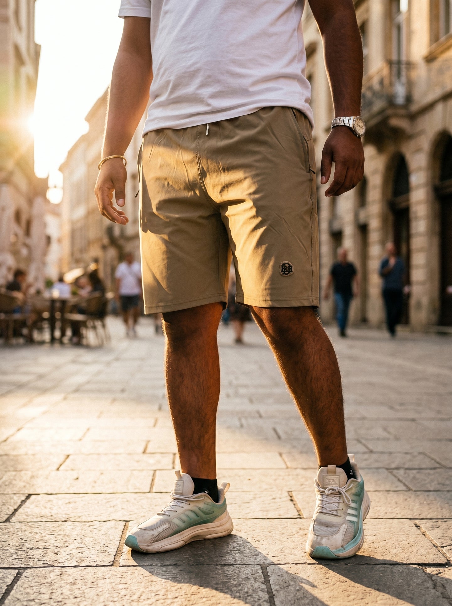 Khaki shorts rear view with elastic waistband, side pockets, and logo patch