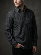 Deep grey denim shirt on model; button front and chest pocket with high-contrast stitching