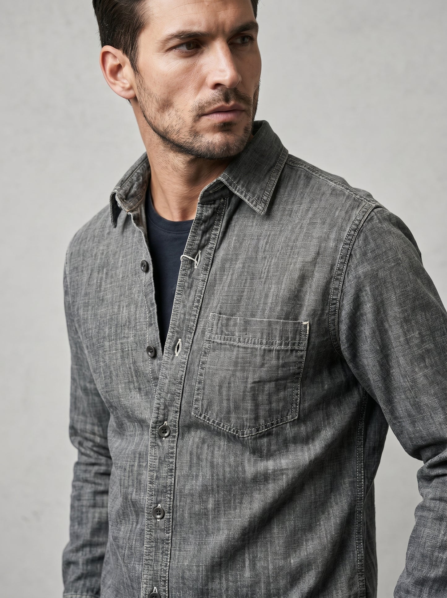 Light grey acid-wash denim shirt close-up with chest pocket and buttons