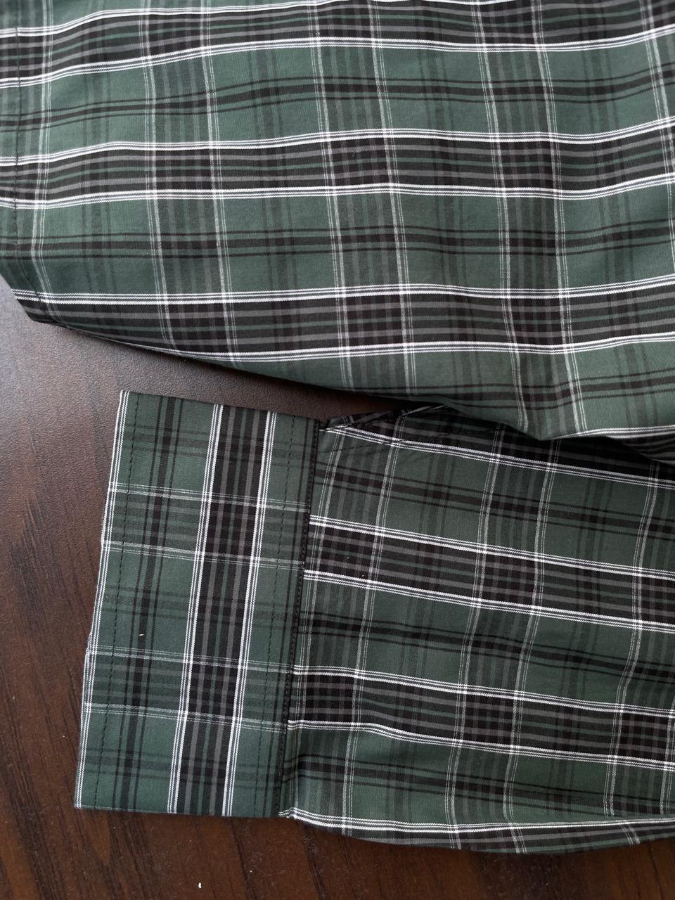 Bottle green tartan check shirt hem and cuff, with button detail