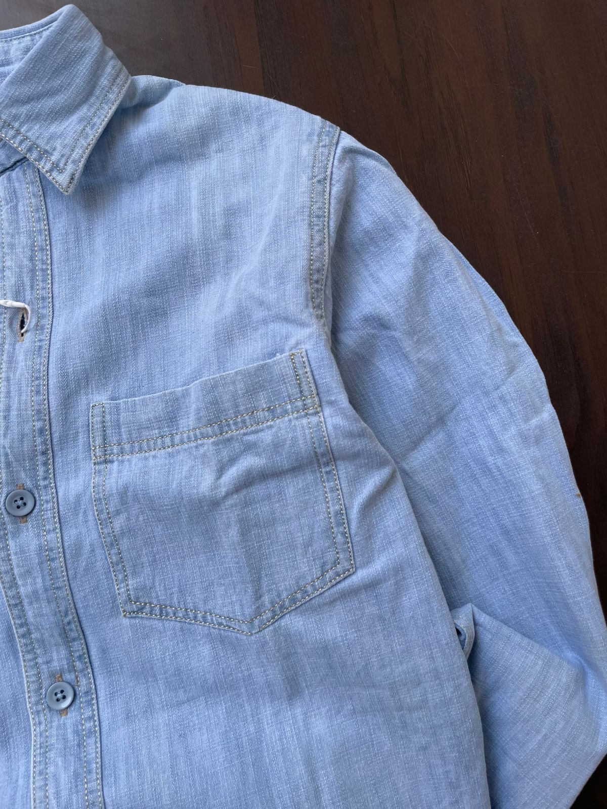 Light blue denim shirt with single chest pocket and button front