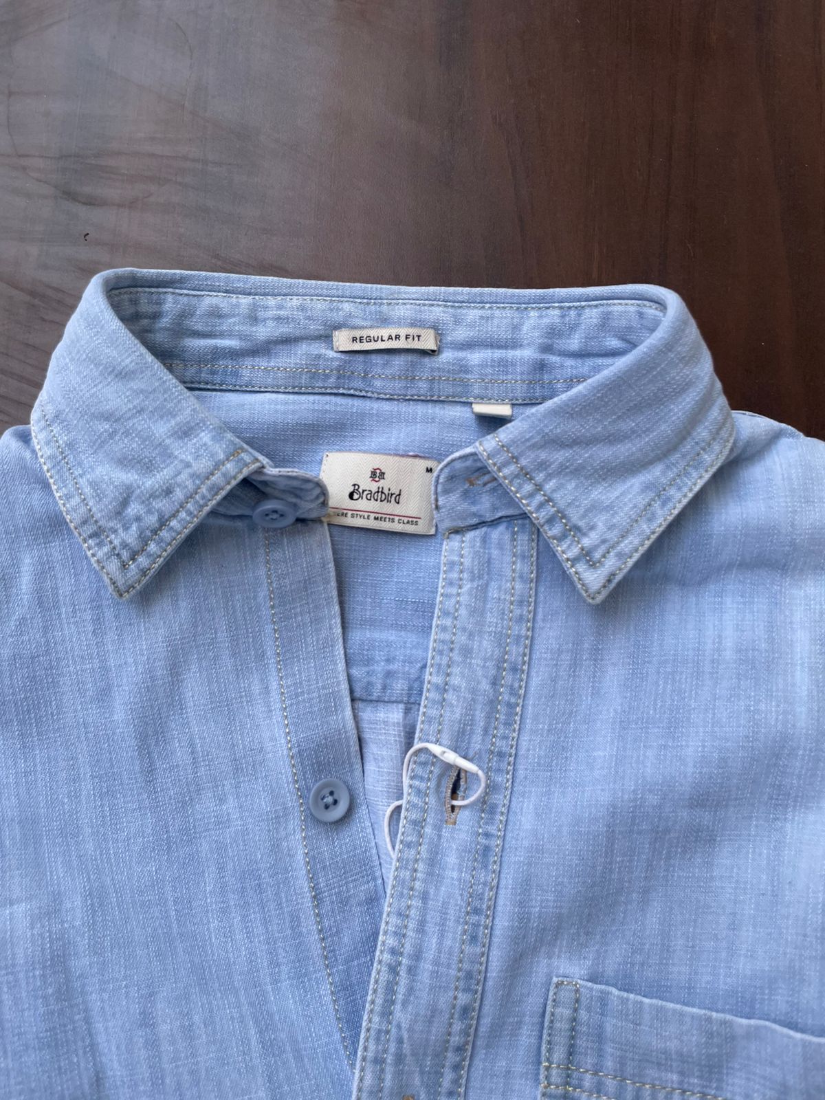 Light blue denim shirt neckline with front buttons and single chest pocket