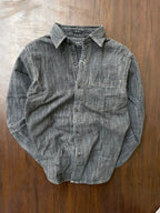 Light grey acid-wash denim button shirt with single chest pocket, laid flat