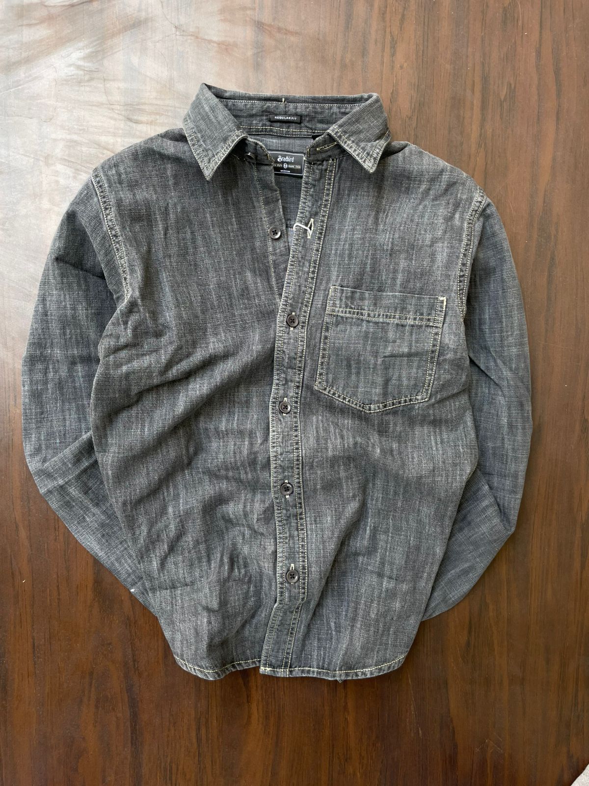 Light grey acid-wash denim button shirt with single chest pocket, laid flat